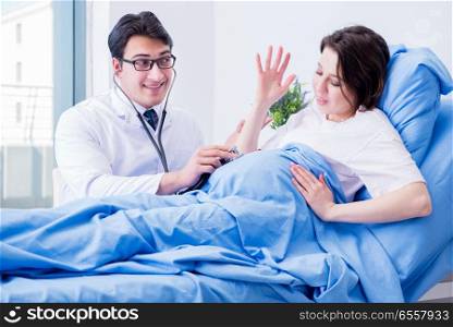 The doctor visiting pregnant in hospital room. Doctor visiting pregnant in hospital room