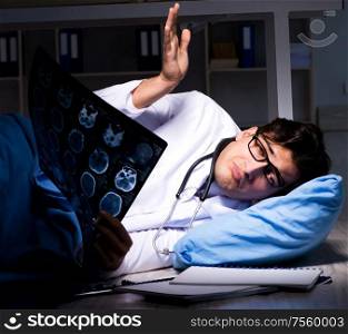 The doctor working night shift in hospital after long hours. Doctor working night shift in hospital after long hours