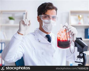 The doctor working with blood samples in hospital clinic lab. Doctor working with blood samples in hospital clinic lab