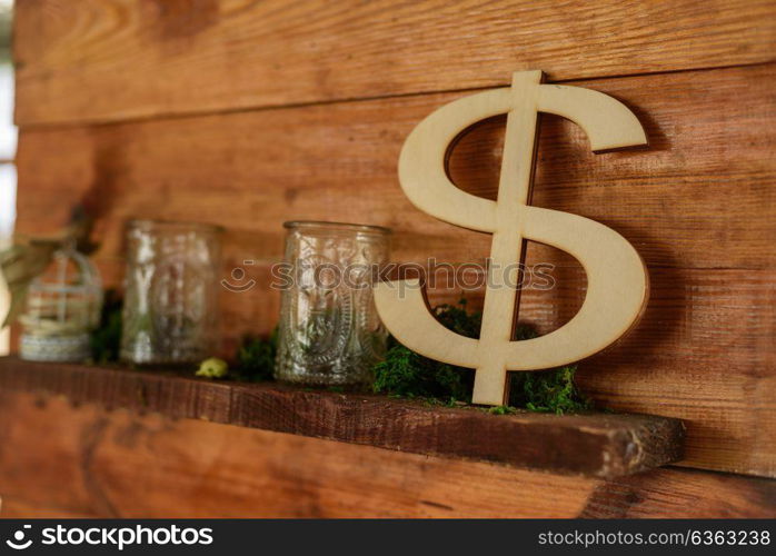 the dollar sign out of wood standing on a wooden shelf decor zone