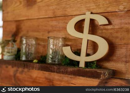 the dollar sign out of wood standing on a wooden shelf decor zone