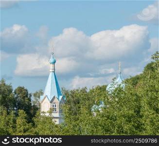 the dome of the wooden Church in the trees. the tower of the Church