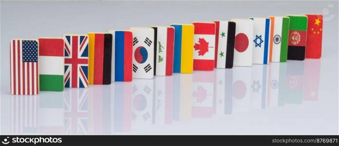 The domino effect with tiles of flags of different countries of the world. conceptual photo, political games. Studio shooting. flags on white surface
