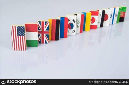 The domino effect with tiles of flags of different countries of the world. conceptual photo, political games. Studio shooting. flags on white surface
