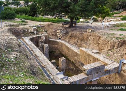 The Double-apsidal Cistern ruins, west of the Sanctuary of Hera Limenia, Greece.. The Double-apsidal Cistern west of the Sanctuary of Hera Limenia, Greece