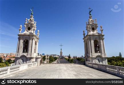 The double clock tower of the late Baroque and Neo-Classical Royal Basilica and Convent of the Most Sacred Heart of Jesus, built in late 18th century in Lisbon, Portugal