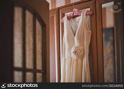 The dress hangs on a hanger.. Wedding dress 2011.