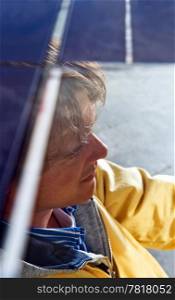 The driver of a solar powered vehicle, seen from above through the glass roof