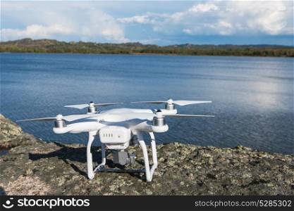 The drone copter with digital camera. The drone copter with digital camera ready to flying on lake background