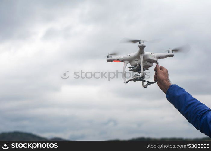 The drone copter with digital camera. The flying drone copter with digital camera and human hand