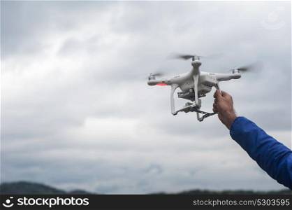 The drone copter with digital camera. The flying drone copter with digital camera and human hand