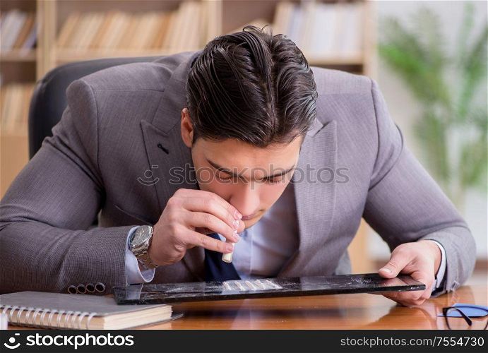 The drug addict businessman in the office. Drug addict businessman in the office