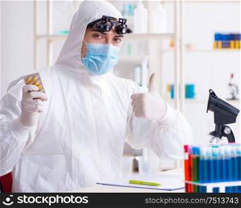 The drug synthesis concept with chemist working in research lab. Drug synthesis concept with chemist working in research lab
