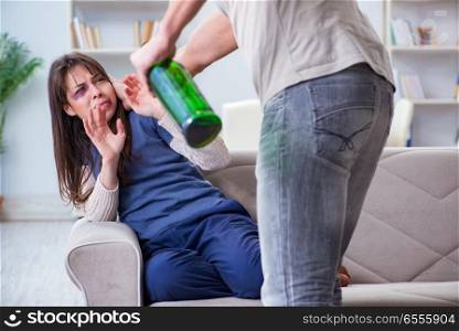 The drunk husband abusing wife in domestic violence concept. Drunk husband abusing wife in domestic violence concept