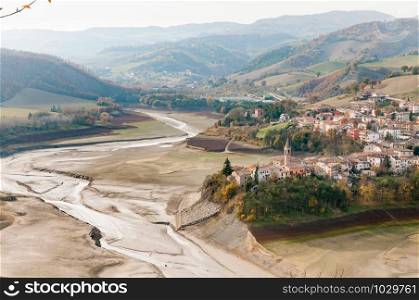 The dry Sassocorvaro lake and the town of Mercatale seen from the heights of Sassocorvaro in the Marche, Italy, Europe