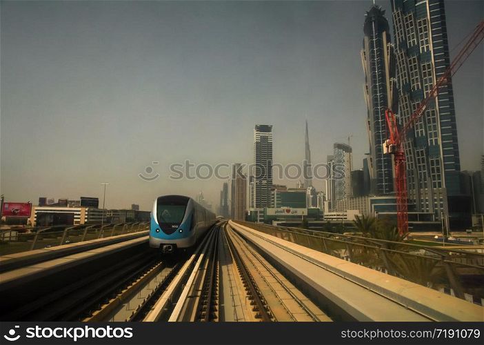 the Dubai Metro, MRT, in motion along Sheikh Zayed road with the skyline in the background, Dubai, United Arab Emirates