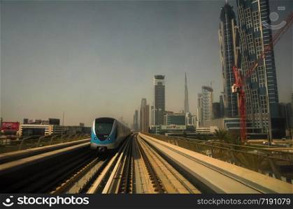 the Dubai Metro, MRT, in motion along Sheikh Zayed road with the skyline in the background, Dubai, United Arab Emirates