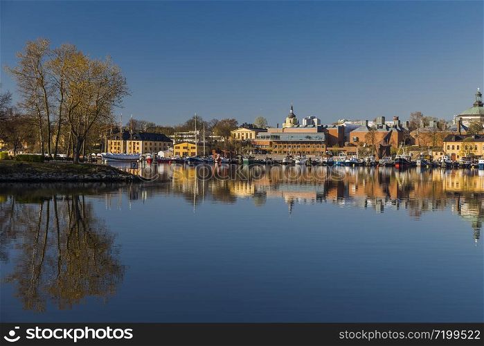 The eastern shore of Skeppsholmen with moored ancient wooden vessels