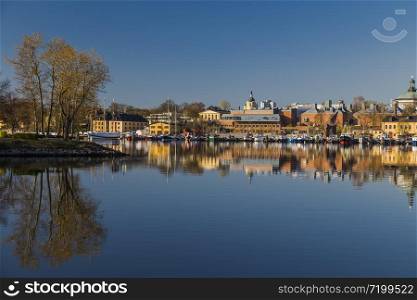 The eastern shore of Skeppsholmen with moored ancient wooden vessels