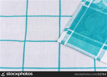 The edge of a tissue napkin with a white-green pattern is wrapped in an angle to the middle