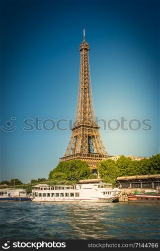 The Eiffel tower and the Seine river with blue clear sky in background Paris France