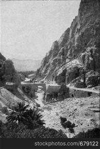 The El Kantara Gorge at the edge of the Sahara, vintage engraved illustration. From the Universe and Humanity, 1910.