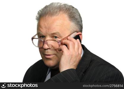The elderly man talks by a mobile phone. It is isolated on a white background