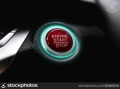 The electric car engine start stop button is illuminated by a green light