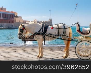 The elegant horse-drawn carriage on the central promenade of Chania.. Chania. Horse-drawn carriage.
