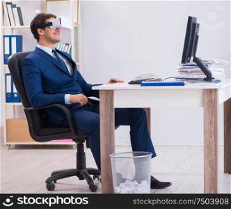 The employee using virtual reality glasses in office. Employee using virtual reality glasses in office