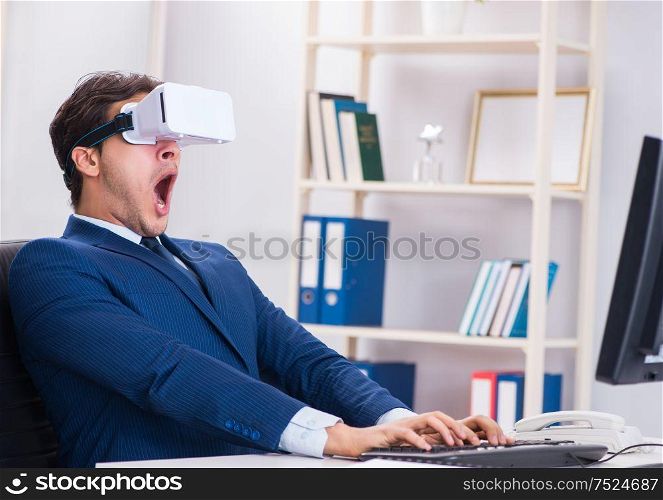 The employee using virtual reality glasses in office. Employee using virtual reality glasses in office