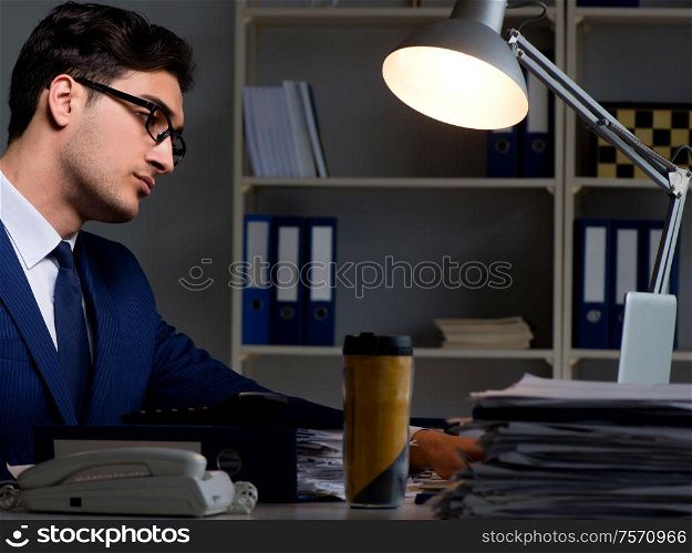 The employee working late to finish important deliverable task. Employee working late to finish important deliverable task