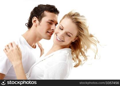 The enamoured young couple embraces on a white background