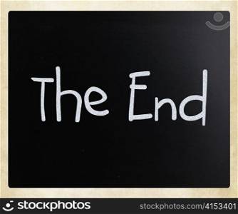 ""The End" handwritten with white chalk on a blackboard"