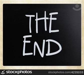 ""The End" handwritten with white chalk on a blackboard."