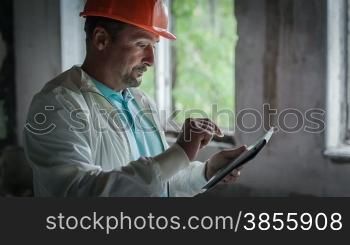 The Engineer Is Getting Acquainted With The Economic Calculations On The Tablet. RAW Video