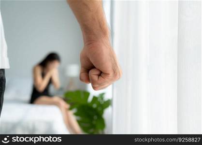 The enraged man tightened his hand to hit the frightened woman in the background. The concept of family and physical abuse