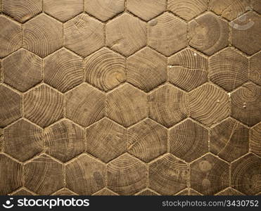 The entrance hall to Trinity College in Dublin is paved with hexagonal wood blocks that form a geometric pattern in a parquet-like floor.