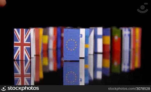 The Eu Dominos Fall. Flags of European Countries like a domino falling down
