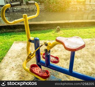 The exercise bike was installed on the cement floor next to the canal. Artificial sunlight . After rain. Healthy lifestyle.