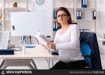The experienced female employee working in the office. Experienced female employee working in the office