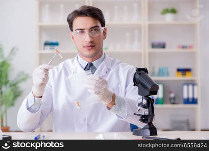 The expert criminologist working in the lab for evidence. Expert criminologist working in the lab for evidence