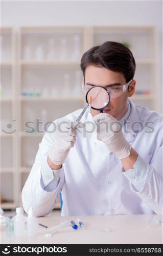 The expert criminologist working in the lab for evidence. Expert criminologist working in the lab for evidence