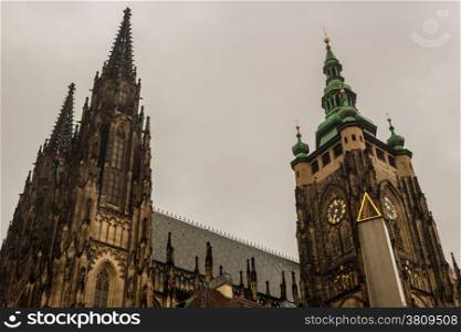 the exterior facade of the cathedral of St Vitus in Prague, a church with dark Gothic towers guarded by gargoyle: the main religious symbol of the Czech Republic