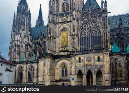 the exterior facade of the cathedral of St Vitus in Prague, a church with dark Gothic towers guarded by gargoyle: the main religious symbol of the Czech Republic