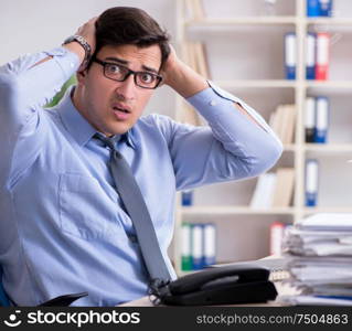 The extremely busy businessman working in office. Extremely busy businessman working in office