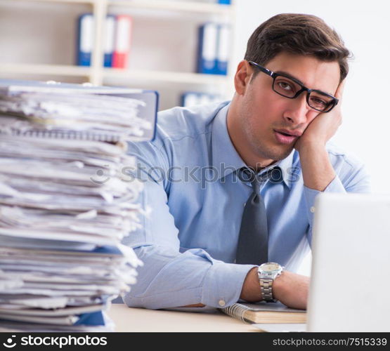 The extremely busy businessman working in office. Extremely busy businessman working in office