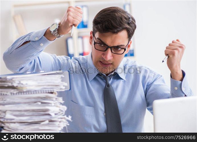 The extremely busy businessman working in office. Extremely busy businessman working in office