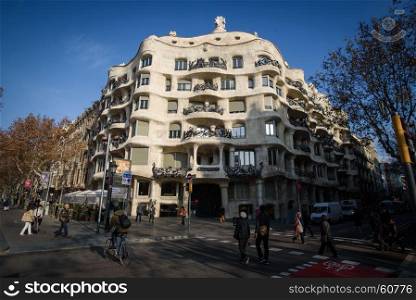 The facade of the house Casa Mila, Barcelona, Spain. Barcelona, Spain - January 28, 2016: The facade of the house Casa Mila designed by Antoni Gaudi.