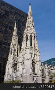 The facade of the Saint Patrick Cathedral in New York City, on a deep blue sky